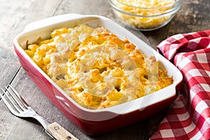 Typical American macaroni and cheese on wooden table