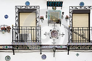 Typical andalusian white village house window and flower decoracion