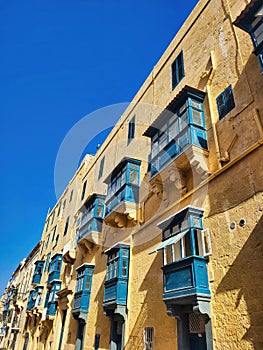 Typical architectural details of the old town. Icicles on the roof of the old house. A closeup of buildings with a blue sky