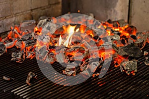 Typical Argentinian barbecue or asado. Burning wood in the grill and red hot coals