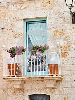 Typical balcony in a stone house of southern Italy.