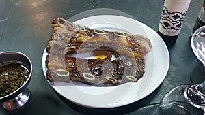 Typical Barbecue from South America with chimichurri sauce. Bife de tira, Montevideu Market, Uruguay. photo