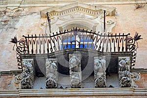 Typical Baroque balcony in Ragusa Sicily Italy photo
