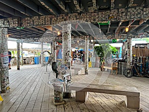 A typical beach restaurant named Robbies with colorful tables, chairs and umbrellas in the Florida Keys