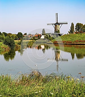 Typical beautiful idyllic dutch countryside landscape, small rural village with old windmill, lake and green meadow - Terheijden