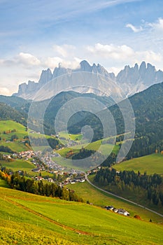 Typical beautiful landscape in the Dolomites,Santa Maddalena village, Val di Funes valley in the background with the Odle