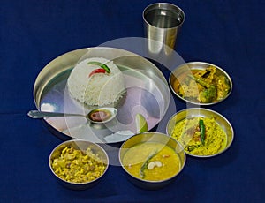 Typical bengali meal of rice, hilsa fish, curry, lentils