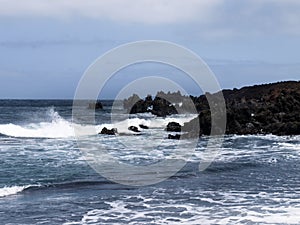 Typical black sand beach of volcanic origin