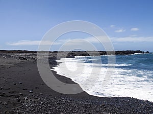 Typical black sand beach of volcanic origin