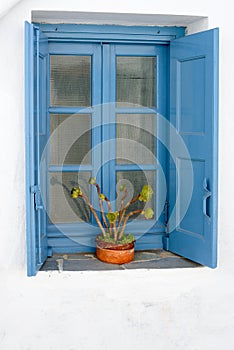 Typical blue wooden window with shutters