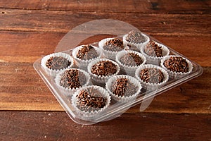 Typical brazilian brigadeiros, various flavors over wooden board photo