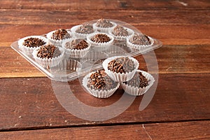 Typical brazilian brigadeiros, various flavors over wooden board photo