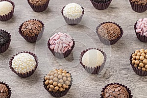 Typical brazilian brigadeiros, various flavors over wooden table