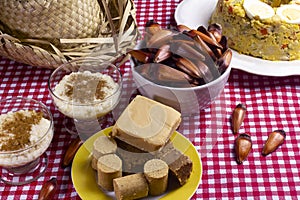 Typical Brazilian junina party food and sweets. Couscouz, peanut candy, sweet rice, dulces de leche and and pine nuts photo