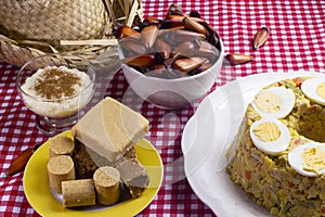 Typical Brazilian junina party food and sweets. Couscouz, peanut candy, sweet rice, dulces de leche and and pine nuts photo