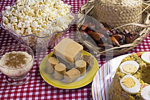 Typical Brazilian junina party food and sweets. Couscouz, peanut candy, sweet rice, dulces de leche and and pine nuts photo