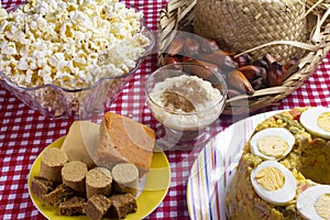 Typical Brazilian junina party food and sweets. Couscouz, peanut candy, sweet rice, dulces de leche and and pine nuts photo