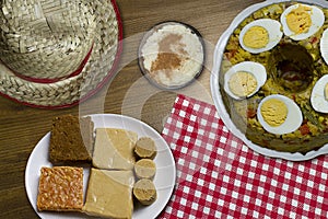 Typical Brazilian junina party food and sweets. Couscouz, peanut candy, sweet rice, dulces de leche and and pine nuts photo