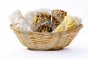 Typical Brazilian sweet, called cocada, in a homemade basket. Isolated white background with copyspace