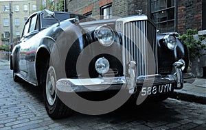 Typical brick house in Shoreditch London with Bentley vintage car