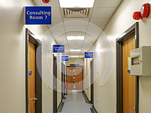 A typical British NHS hospital corridor showing consultation and treatment rooms