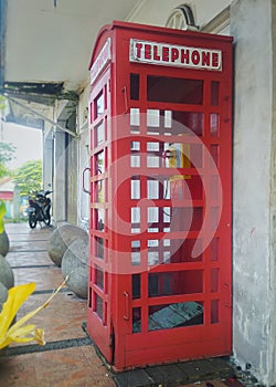 A typical British red telephone booth on a city street