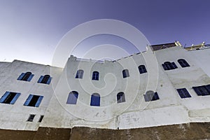 Typical building whit Moroccan windows, against a deep blue sky, Azemmour, El Jadida