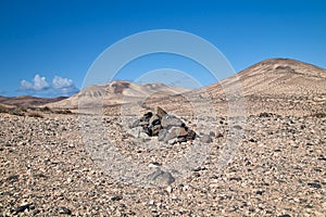typical cairn marking and landscape in the interior of the Canary Island of Fuerteventura