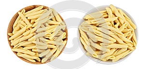 Typical Calabrian pasta called Maccheroncini or Maccheroni in wooden bowl isolated on white background . Top view. Flat