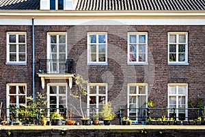 Typical canal houses with the famous Amsterdam posts along the sidewalk