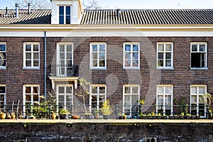 Typical canal houses with the famous Amsterdam posts along the sidewalk
