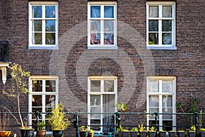 Typical canal houses with the famous Amsterdam posts along the sidewalk