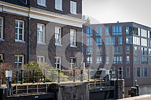 Typical canal houses with the famous Amsterdam posts along the sidewalk