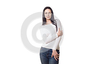 Typical caucasian woman model, classic posing in the studio. A tall thin beautiful girl with long hair in jeans and