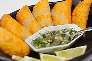 Typical Colombian empanadas served with spicy sauce photo