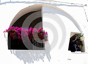 Typical colorful and covered balcony with arch in a hot day in P