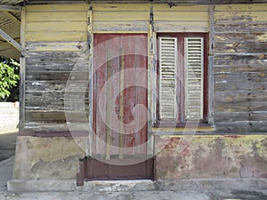 Rusty wooden colorful house in Martinique, French West Indies. Tropical multicolor windows