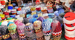 Typical colorful knitted and woven Moroccan hats on display for sale