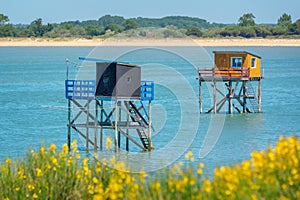 Typical and colorful wooden fishing huts on stilts in the atlantic ocean near La Rochelle France