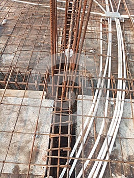 Typical column beam junction at mid span of a building work with pvc electrical conduits laid below top steel & above bottom steel