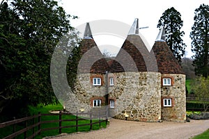 Typical converted Oast House in a remote setting in a village in Kent, England, UK. Oast houses in group constructed photo