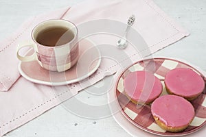 Dutch cake with pink frosting, called Roze Koek, against white grey backgruond photo