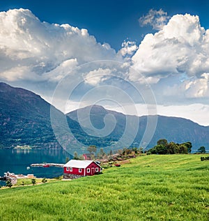 Typical countryside Norwegian landscape with red painted wall house. Picturesque summer morning in Norway, Europe. Beauty of