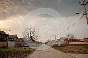 Typical countryside road in the village of Banatsko novo selo, a serbian village of the Banat region of Vojvodina, Serbia, at dusk