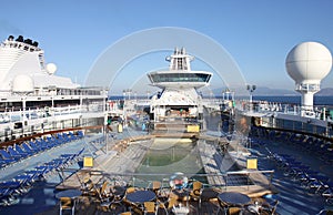 Typical Cruise ship deck with swimming pool,sunbeds and bar