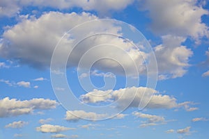 Typical cumulus clouds with the characteristic flat-bottomed puffy shape associated with cumulus clouds against a blue sky in