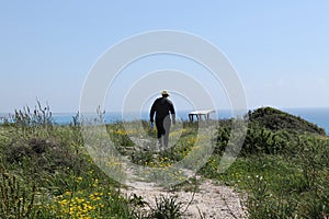 Typical czech tourist in Ancient Kourion park, in Episkopi, Cyprus. Traveler goes on vantage point with outlook of mediterranean