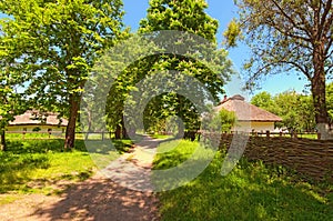 Typical dirt road with wicker old fence in ancient Ukrainian village.  Pereyaslav-Khmelnitsky Museum of Folk Architecture