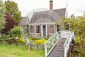Typical Dutch brick house with water channe, garden and wooden