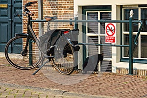 Typical Dutch disobedience of parking a bicycle right next to a no-parking for bicycles sign